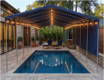 Blue patio cover over a pool with outdoor furniture and plants.