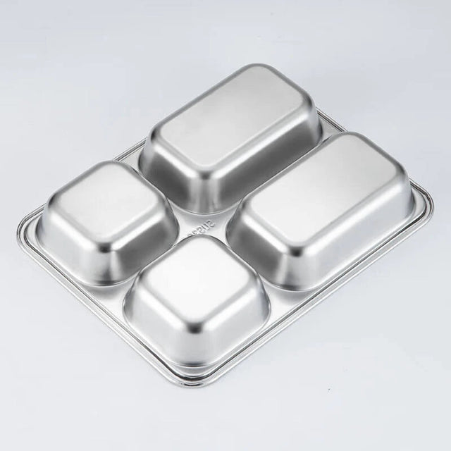 Four compartment stainless steel cube tray on a light gray background